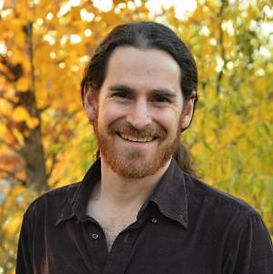 eyal smiles with autumn leaves in the background